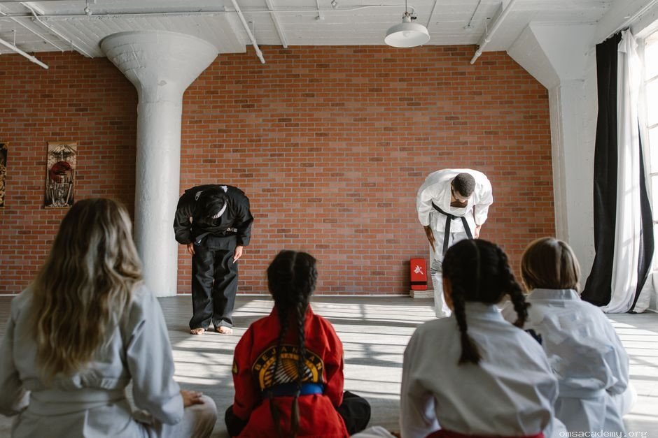 Martial arts students bowing to their instructor during a Taekwondo class at Om's Martial Arts & Fitness Studio in Jaipur.