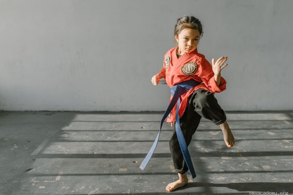 Young girl practicing Taekwondo kicks during a martial arts class at Om's Martial Arts & Fitness Studio in Jaipur.
