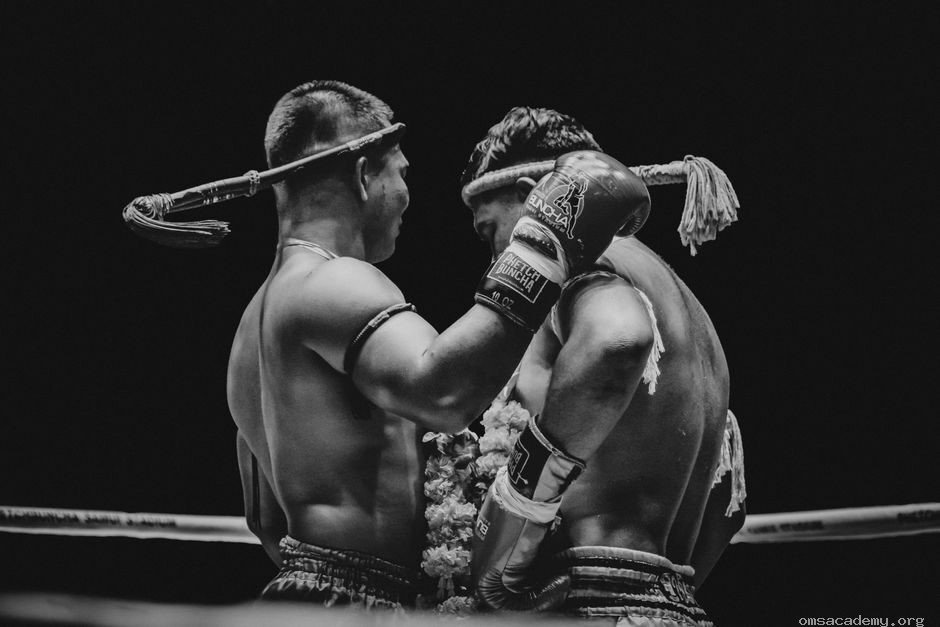 Two Muay Thai fighters showing mutual respect and sportsmanship in the ring at Om's Martial Arts & Fitness Studio